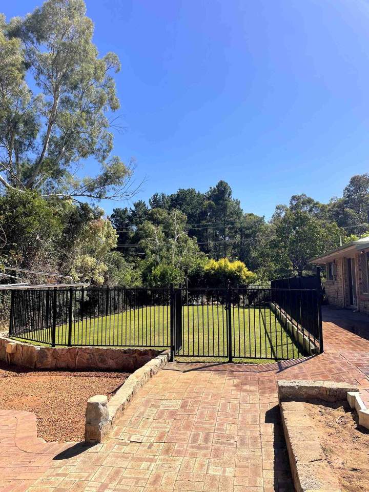 Garden with Green Lawn in a Backyard Paved Perth